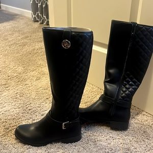 Liz Claiborne  black leather boots sit right below the knee